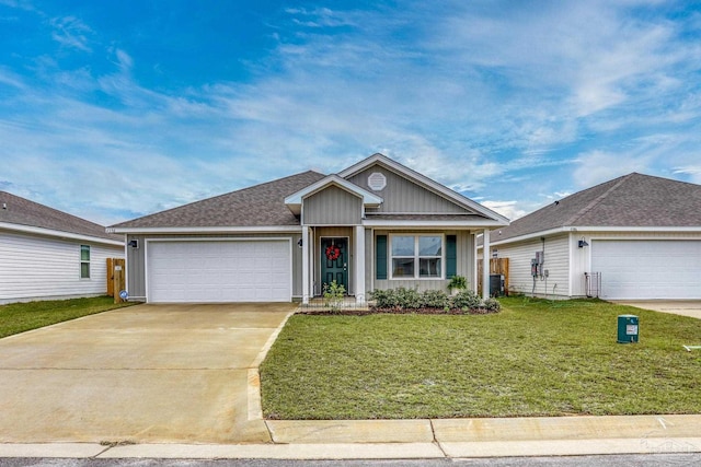 view of front of home featuring a garage, driveway, a shingled roof, and a front yard