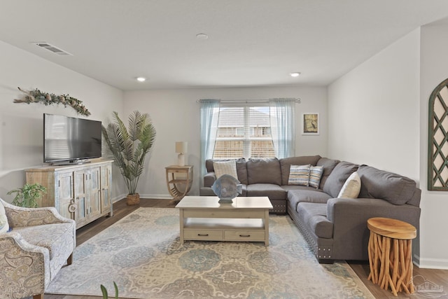 living area with recessed lighting, wood finished floors, visible vents, and baseboards