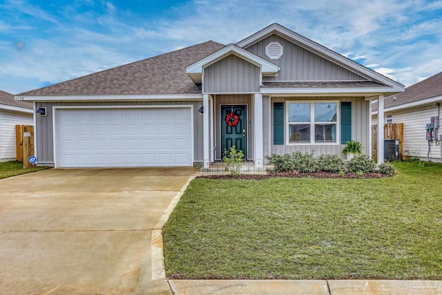 single story home featuring driveway, roof with shingles, an attached garage, board and batten siding, and a front yard