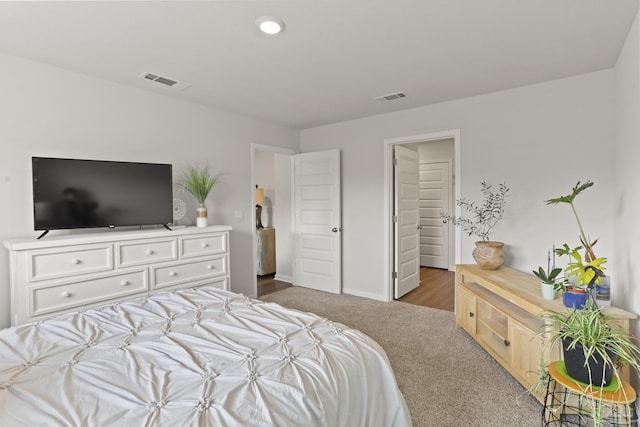 carpeted bedroom with baseboards and visible vents