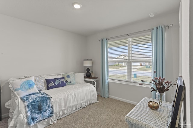 bedroom featuring carpet and baseboards