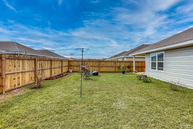 view of yard with a fenced backyard