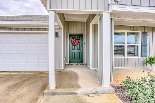 property entrance featuring an attached garage and board and batten siding