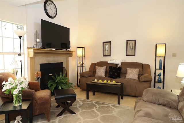 living room featuring a tiled fireplace