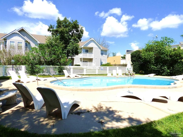 view of swimming pool featuring a diving board