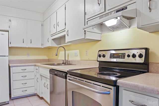 kitchen with sink, white cabinetry, light tile patterned floors, crown molding, and appliances with stainless steel finishes