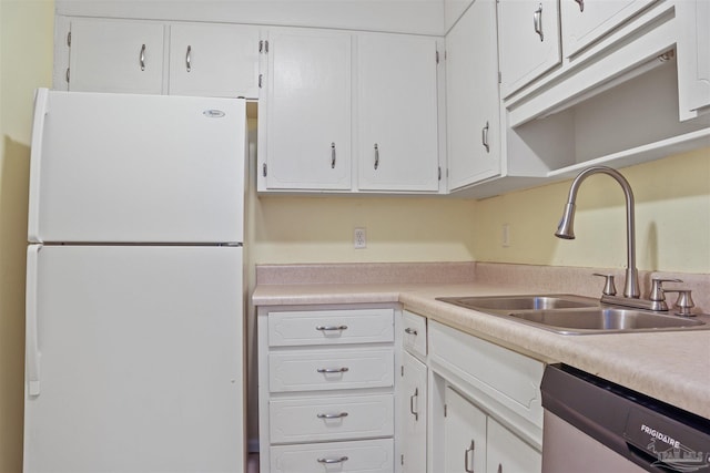 kitchen featuring white fridge, stainless steel dishwasher, white cabinetry, and sink