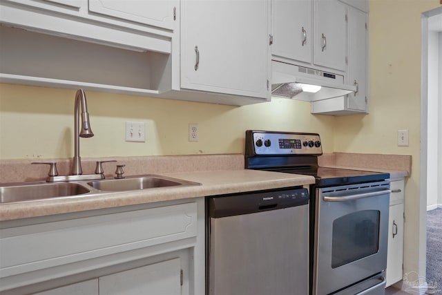 kitchen with appliances with stainless steel finishes, white cabinetry, and sink