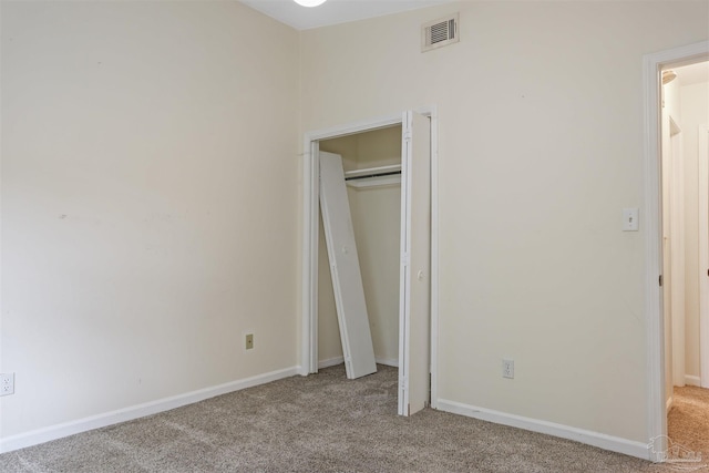 unfurnished bedroom featuring light carpet