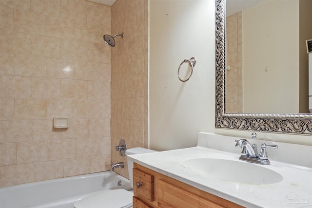 full bathroom featuring toilet, tiled shower / bath, and vanity