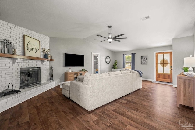 4684 Evelyn St, Pace, FL 32571 - living area with a ceiling fan, a brick fireplace, dark wood-style flooring, lofted ceiling, and baseboards