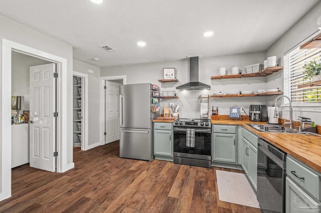 4684 Evelyn St, Pace, FL 32571 - kitchen featuring wooden counters, appliances with stainless steel finishes, wall chimney exhaust hood, a sink, and recessed lighting
