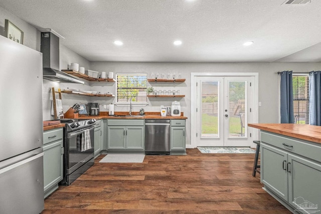 4684 Evelyn St, Pace, FL 32571 - kitchen featuring wood counters, stainless steel appliances, a sink, french doors, and wall chimney range hood