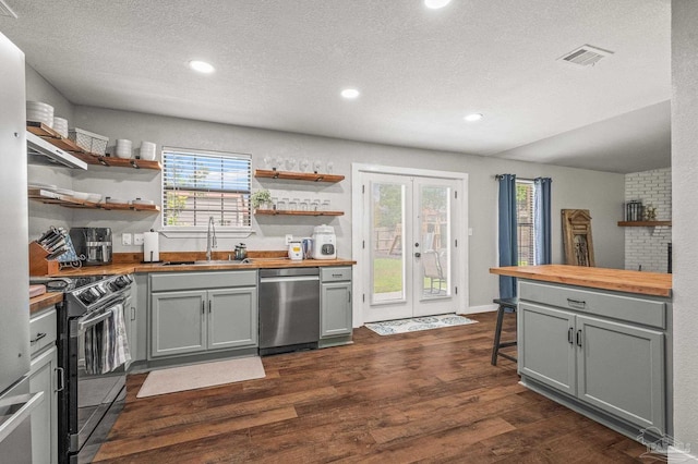 4684 Evelyn St, Pace, FL 32571 - kitchen with butcher block counters, dishwasher, a sink, black range with electric stovetop, and a textured ceiling