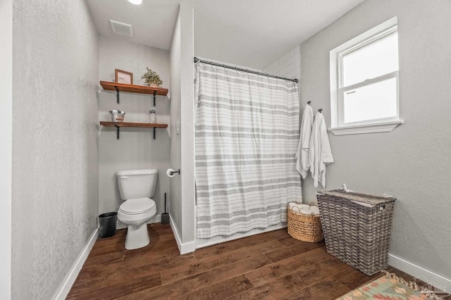 4684 Evelyn St, Pace, FL 32571 - bathroom featuring wood finished floors, toilet, a shower with curtain, a textured wall, and baseboards