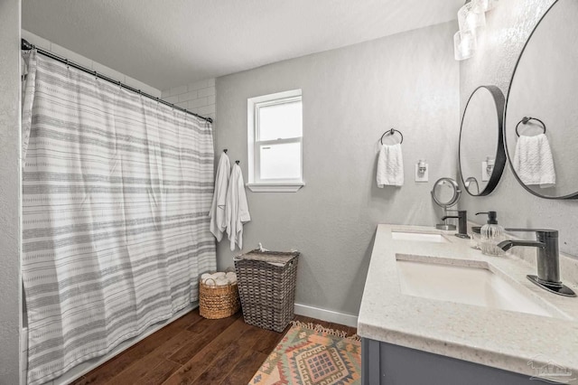 4684 Evelyn St, Pace, FL 32571 - bathroom with double vanity, wood finished floors, baseboards, and a shower with shower curtain