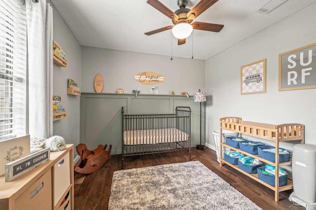 4684 Evelyn St, Pace, FL 32571 - bedroom featuring wood-type flooring, a crib, and a ceiling fan