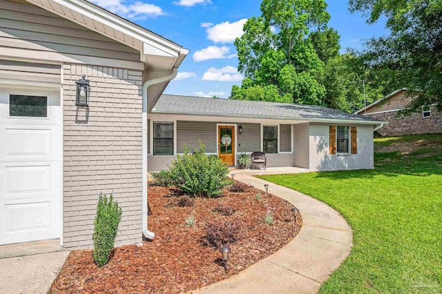4684 Evelyn St, Pace, FL 32571 - entrance to property featuring brick siding, a lawn, and a garage