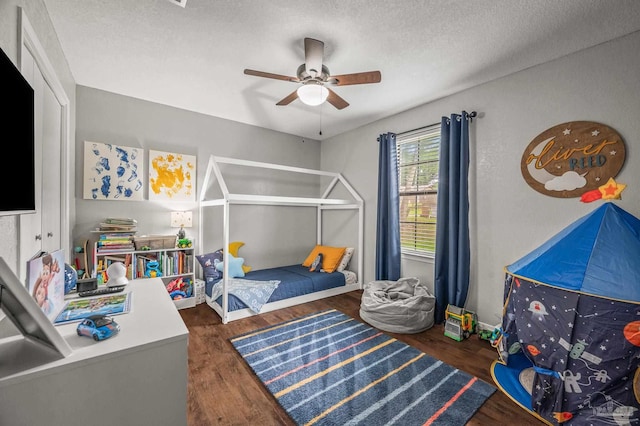 4684 Evelyn St, Pace, FL 32571 - bedroom featuring wood finished floors, a textured ceiling, and ceiling fan