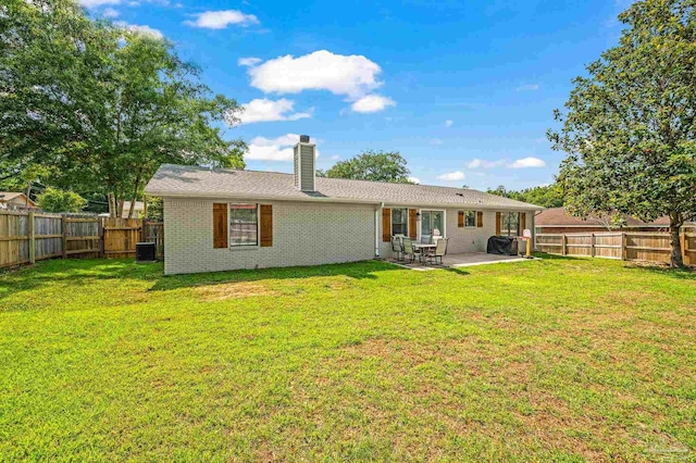4684 Evelyn St, Pace, FL 32571 - back of property featuring a chimney, a patio area, and brick siding