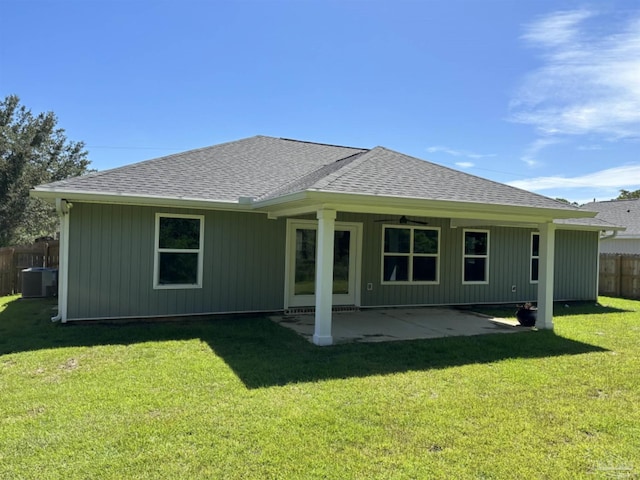 back of house with a patio, central air condition unit, and a lawn