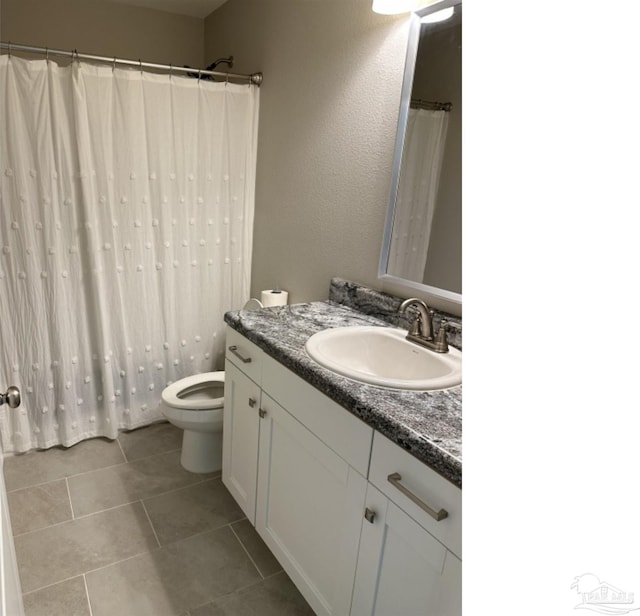 bathroom with vanity, tile patterned floors, and toilet