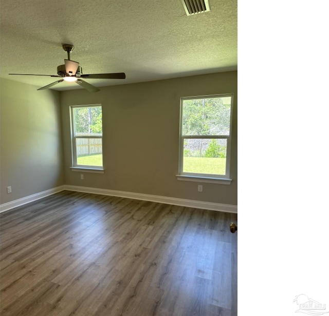 unfurnished room with a textured ceiling, ceiling fan, and hardwood / wood-style floors