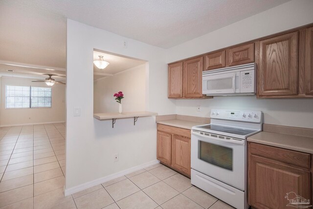 kitchen with light tile patterned flooring, white appliances, kitchen peninsula, a textured ceiling, and ceiling fan