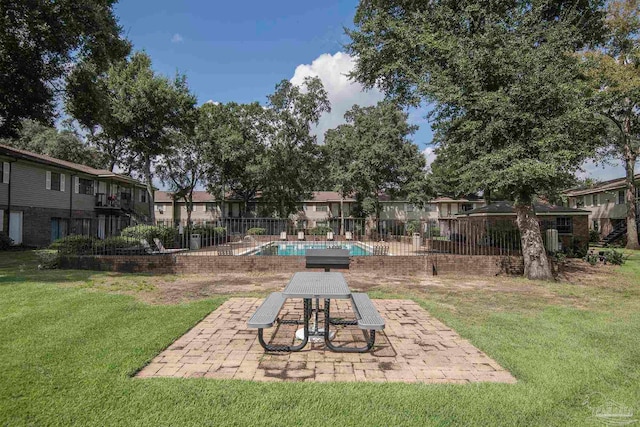 view of yard with a community pool and a patio