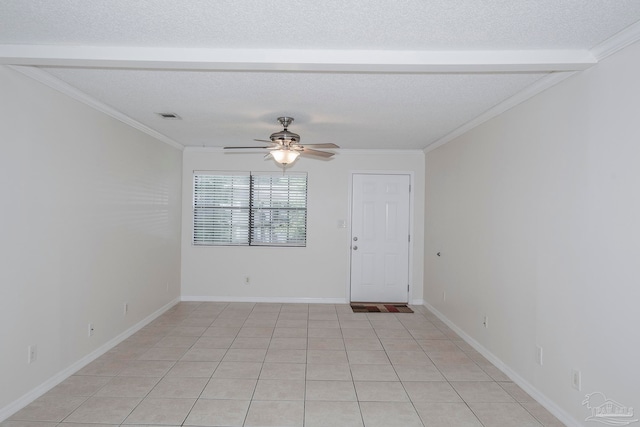 tiled empty room with ornamental molding, ceiling fan, and a textured ceiling