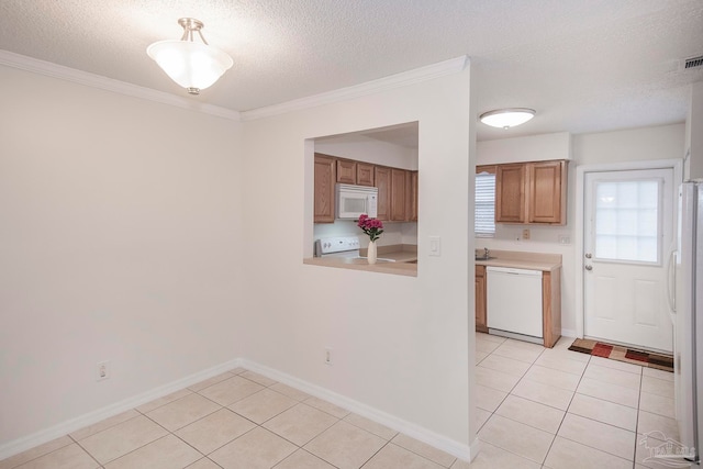 kitchen featuring white appliances, ornamental molding, and light tile patterned floors