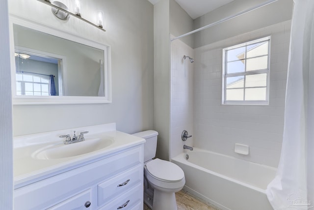 full bath with toilet, shower / bath combo with shower curtain, and vanity