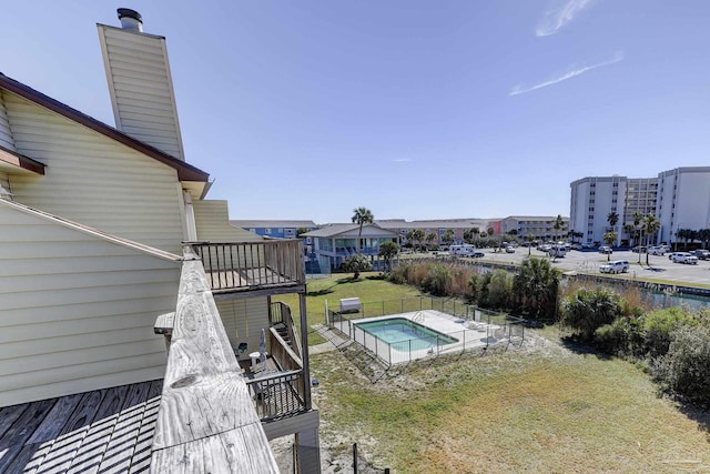 view of pool with a yard and fence