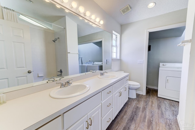 full bath featuring a shower, visible vents, a sink, and wood finished floors