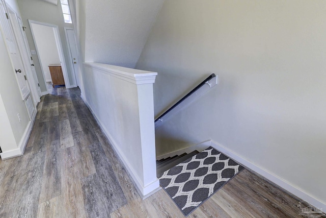 stairs with wood finished floors and baseboards