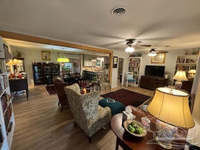 living room featuring ceiling fan and hardwood / wood-style floors