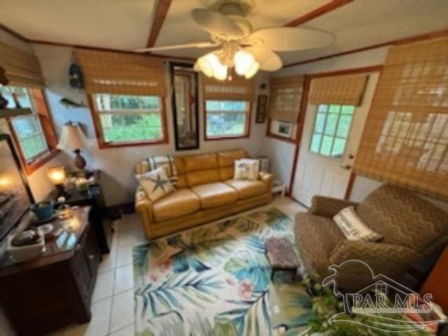 living room featuring light tile patterned floors, a wealth of natural light, and ceiling fan