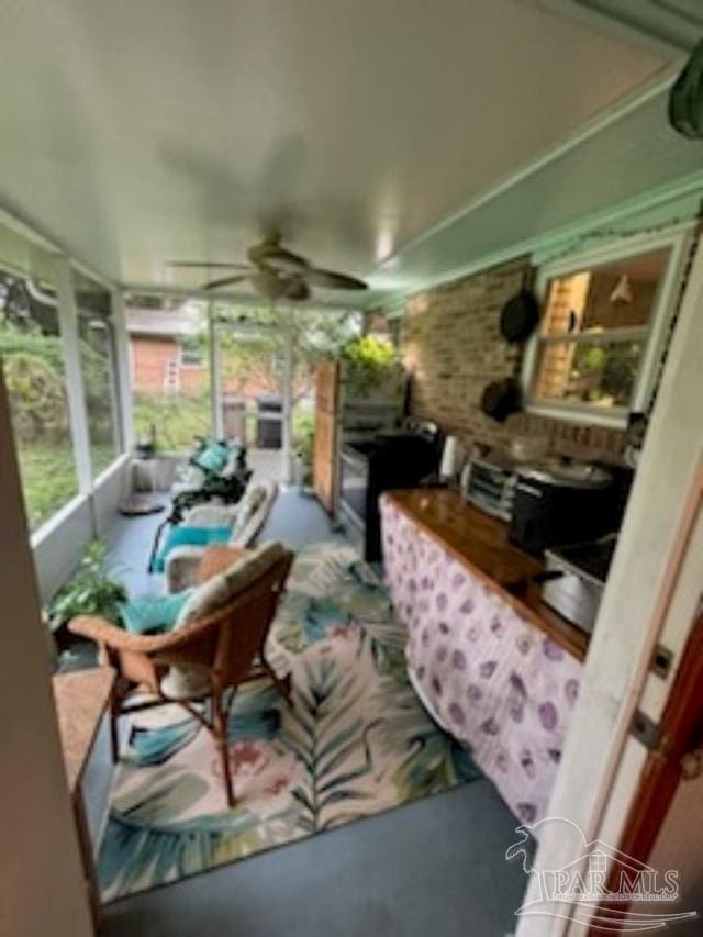 sunroom featuring ceiling fan