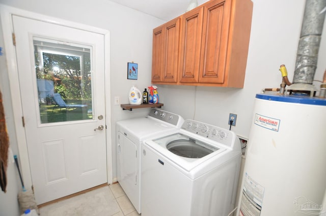 laundry room with washer and dryer, light tile patterned flooring, cabinets, and water heater