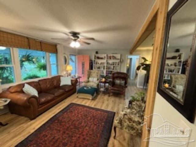 living room featuring hardwood / wood-style flooring and ceiling fan