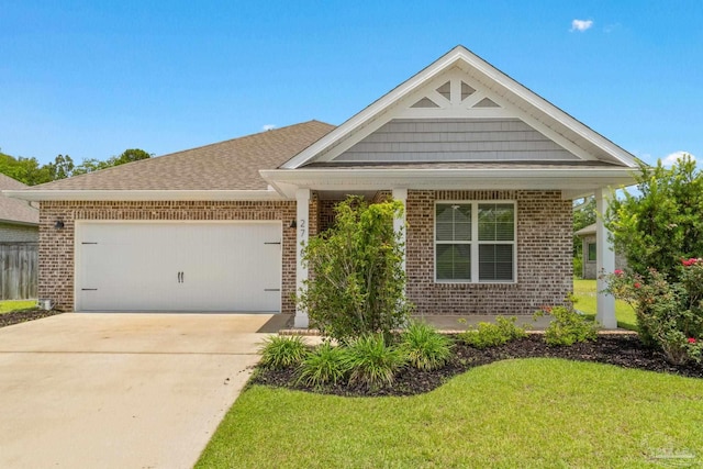 2748 Woodman Loop, Cantonment, FL 32533 - view of front of property with brick siding, a garage, a front lawn, and driveway
