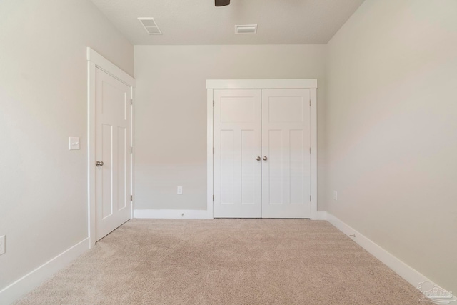 2748 Woodman Loop, Cantonment, FL 32533 - unfurnished bedroom with carpet flooring, baseboards, a closet, and ceiling fan
