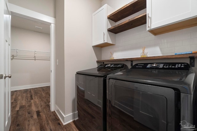 2748 Woodman Loop, Cantonment, FL 32533 - washroom featuring independent washer and dryer, cabinet space, dark wood finished floors, and baseboards