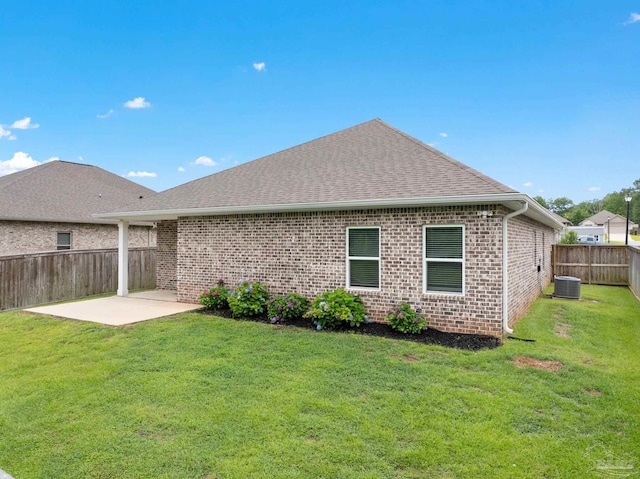 2748 Woodman Loop, Cantonment, FL 32533 - back of property with brick siding, cooling unit, a patio area, and a shingled roof