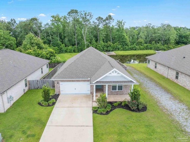 2748 Woodman Loop, Cantonment, FL 32533 - view of front of home with driveway, brick siding, a garage, and a water view