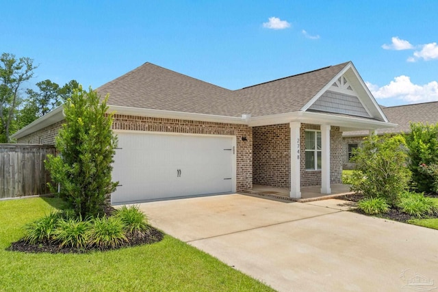 2748 Woodman Loop, Cantonment, FL 32533 - view of front of home with an attached garage, brick siding, roof with shingles, and concrete driveway