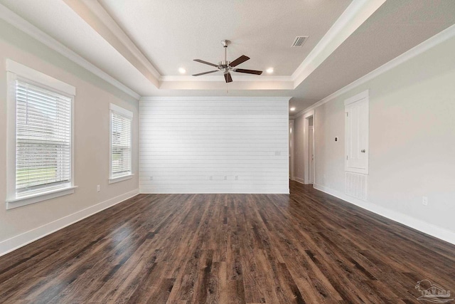 2748 Woodman Loop, Cantonment, FL 32533 - unfurnished room with a tray ceiling, ceiling fan, dark wood finished floors, crown molding, and baseboards