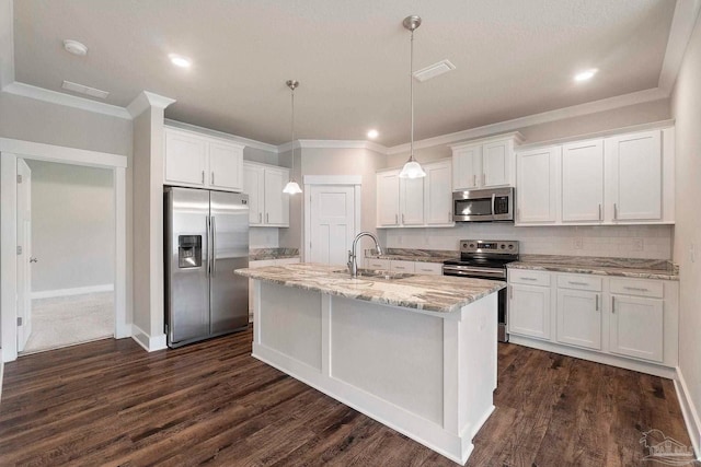 2748 Woodman Loop, Cantonment, FL 32533 - kitchen featuring appliances with stainless steel finishes, a sink, ornamental molding, white cabinets, and a center island with sink