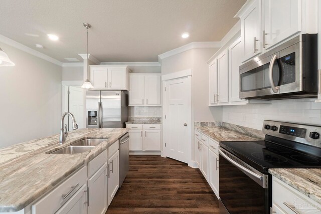 2748 Woodman Loop, Cantonment, FL 32533 - kitchen featuring appliances with stainless steel finishes, a sink, ornamental molding, white cabinets, and recessed lighting