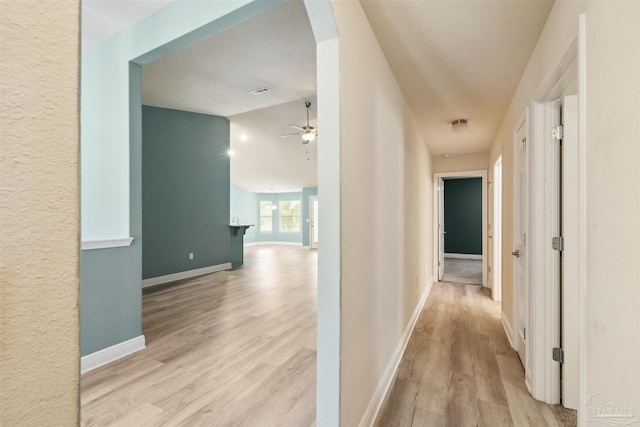 hallway with light hardwood / wood-style floors